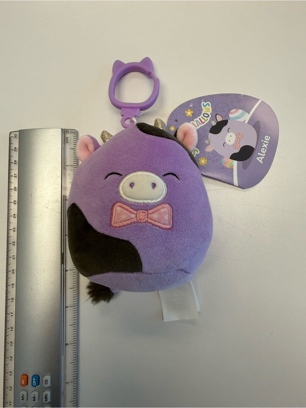 NWT 4 inch Alexie the Cow Squishmallow Purple Easter Clip-On Plush Toy - Picture 2 of 4
